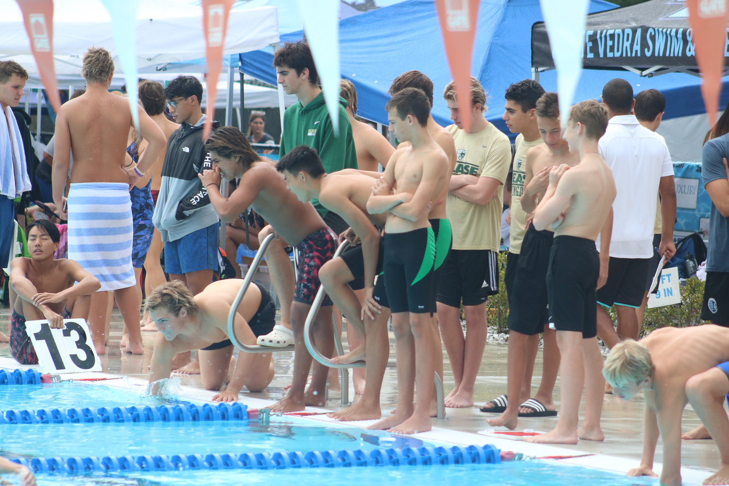 Members of the Nease swim team cheer on one of the teammates during a race.